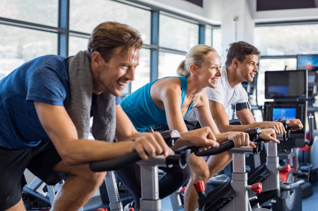 People in a gym on exercise bikes