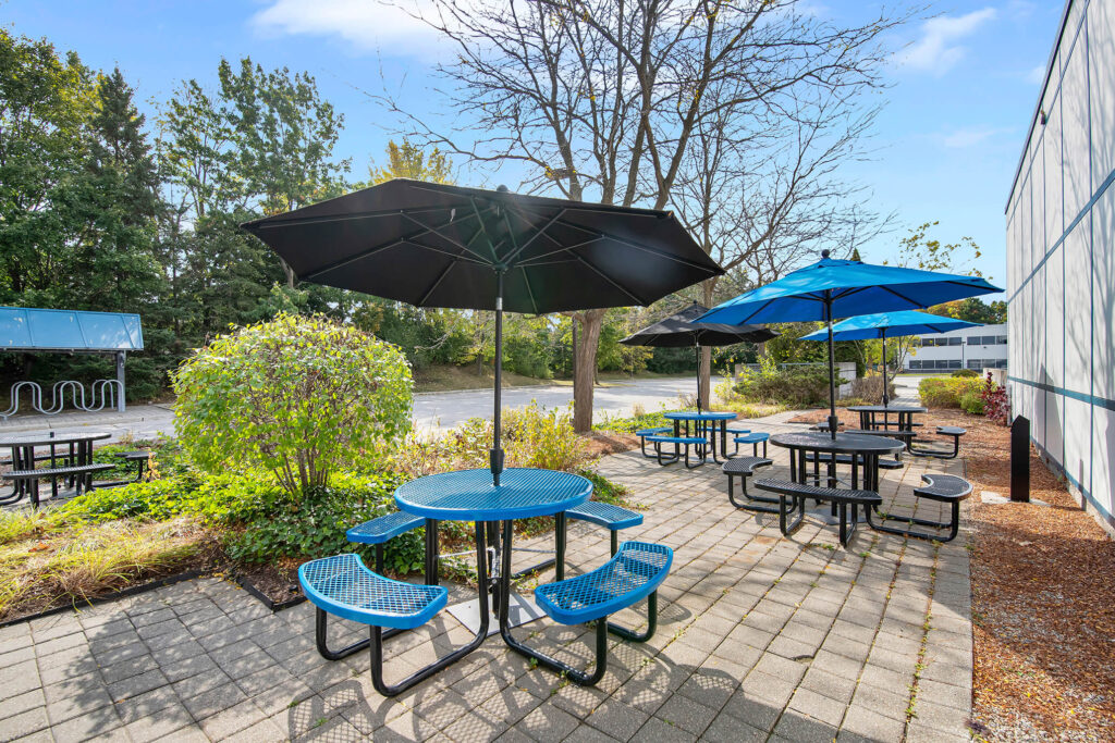 Outdoor patio with blue benches and umbrellas